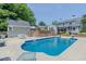 Backyard pool with concrete patio, surrounded by lush landscaping and home exterior at 1110 Edgewood Ave, Burlington, NC 27215