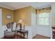 Sitting area with a decorative chair, side table, and window providing natural light at 1110 Edgewood Ave, Burlington, NC 27215
