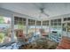 Bright sunroom with checkered floors, wicker furniture, and views of the pool and landscaped yard at 1110 Edgewood Ave, Burlington, NC 27215
