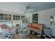 Cozy sunroom featuring white wicker furniture and a decorative ceiling fan at 1110 Edgewood Ave, Burlington, NC 27215