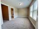 Bedroom with natural light, carpeted floors, and an attached bathroom, providing a comfortable space at 115 Ballyliffen Ln, Cary, NC 27519
