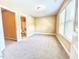 Bedroom with natural light, carpeted floors, and an attached bathroom, providing a comfortable space at 115 Ballyliffen Ln, Cary, NC 27519