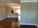 Neutral living area with hardwood floors and view into the kitchen at 115 Ballyliffen Ln, Cary, NC 27519