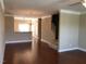 Open-concept living area with hardwood floors connecting to the kitchen at 115 Ballyliffen Ln, Cary, NC 27519