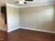 Spacious living room with hardwood floors, neutral walls, and staircase at 115 Ballyliffen Ln, Cary, NC 27519