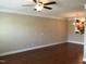 Living space with hardwood floors, ceiling fan, and open view of the kitchen at 115 Ballyliffen Ln, Cary, NC 27519
