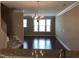 Bright living room features hardwood floors, natural light, and an adjacent kitchen, perfect for modern living at 115 Ballyliffen Ln, Cary, NC 27519