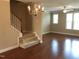 Inviting living room with gleaming hardwood floors and elegant chandelier lighting at 115 Ballyliffen Ln, Cary, NC 27519