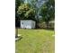 Backyard with a storage shed, trees, clothes line and green lawn at 1210 Fayetteville St, Smithfield, NC 27577