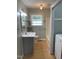 Bathroom featuring a gray vanity with a white sink, a window, and a shower/tub combo at 1210 Fayetteville St, Smithfield, NC 27577