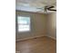 Bedroom features a ceiling fan, wood-look flooring, and natural light from the window at 1210 Fayetteville St, Smithfield, NC 27577