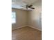 A cozy bedroom featuring wood-look floors, neutral walls, and a ceiling fan with light at 1210 Fayetteville St, Smithfield, NC 27577