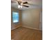 Bedroom features a ceiling fan, wood-look flooring, and natural light from the window at 1210 Fayetteville St, Smithfield, NC 27577