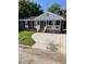 Charming brick home with a covered front porch, well-maintained lawn, and concrete driveway at 1210 Fayetteville St, Smithfield, NC 27577