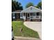 Charming brick home with a covered front porch, well-maintained lawn, and concrete driveway at 1210 Fayetteville St, Smithfield, NC 27577