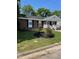 Charming brick home with a covered front porch, well-maintained landscaping, and black shutters at 1210 Fayetteville St, Smithfield, NC 27577