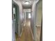 Hallway with neutral walls and wood-look flooring connecting various rooms of the home at 1210 Fayetteville St, Smithfield, NC 27577