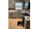Well-lit kitchen featuring a stainless steel dishwasher, range, and complementary countertops at 1210 Fayetteville St, Smithfield, NC 27577