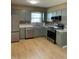 Spacious kitchen features stainless steel appliances, gray cabinets, and modern countertops at 1210 Fayetteville St, Smithfield, NC 27577
