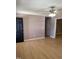 Spacious living room featuring wood-look floors, ceiling fan and neutral wall paint at 1210 Fayetteville St, Smithfield, NC 27577