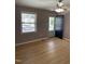 Bright living room featuring wood-look floors, a ceiling fan, and a window with natural light at 1210 Fayetteville St, Smithfield, NC 27577