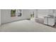 Bright living room with large windows, sleek wood floors, and fresh white walls at 1214 Pond Overlook Drive, Nashville, NC 27856