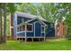 A spacious backyard with a screened-in porch and lush greenery creates a serene outdoor living space at 1218 Chimney Hill Dr, Apex, NC 27502