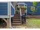 Outdoor barbecue area with a grill and stairs leading to the screened-in porch at 1218 Chimney Hill Dr, Apex, NC 27502