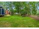 A large, well-maintained backyard featuring a picnic table and bordered by mature trees at 1218 Chimney Hill Dr, Apex, NC 27502
