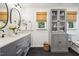 Charming bathroom with double vanity, gray cabinets, and a decorative basket at 1218 Chimney Hill Dr, Apex, NC 27502
