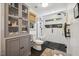 Modern bathroom with new fixtures, tiled walk-in shower, glass door, and woven shade at 1218 Chimney Hill Dr, Apex, NC 27502