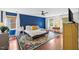 This bedroom offers a colorful rug, hardwood floors, blue accent wall, and bright natural light at 1218 Chimney Hill Dr, Apex, NC 27502