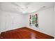 Spacious bedroom featuring hardwood floors, a ceiling fan, and bright natural light at 1218 Chimney Hill Dr, Apex, NC 27502