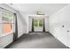 Spacious, carpeted room featuring bright natural light and a ceiling fan at 1218 Chimney Hill Dr, Apex, NC 27502