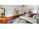 This bedroom offers a colorful rug, hardwood floors, light walls, closet, and bright natural light at 1218 Chimney Hill Dr, Apex, NC 27502