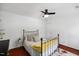 Well-lit bedroom with hardwood floors, ceiling fan, and comfortable furnishings at 1218 Chimney Hill Dr, Apex, NC 27502