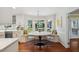 Bright breakfast nook featuring bay window, custom seating, hardwood floors and a modern chandelier at 1218 Chimney Hill Dr, Apex, NC 27502