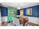 Stylish dining room with blue walls, hardwood floors, and modern chandelier at 1218 Chimney Hill Dr, Apex, NC 27502