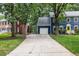 Long driveway leading to a two-story blue home with a garage, surrounded by mature trees at 1218 Chimney Hill Dr, Apex, NC 27502