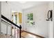 Light-filled entryway with hardwood floors, stairs, and a white door leading to the outdoors at 1218 Chimney Hill Dr, Apex, NC 27502