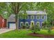 Charming two-story home with a bright yellow door, landscaped yard, and attached garage at 1218 Chimney Hill Dr, Apex, NC 27502