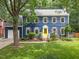 Charming two-story home with blue siding, gray shutters and a bright yellow front door at 1218 Chimney Hill Dr, Apex, NC 27502