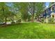 Well-manicured front yard with lush green grass and mature trees at 1218 Chimney Hill Dr, Apex, NC 27502