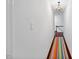 Bright upstairs hallway with a colorful rug and chandelier at 1218 Chimney Hill Dr, Apex, NC 27502