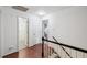 Bright hallway features hardwood floors, white trim and doors, with bathroom and bedroom access at 1218 Chimney Hill Dr, Apex, NC 27502