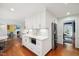 Open kitchen design with white cabinets and a stainless steel refrigerator at 1218 Chimney Hill Dr, Apex, NC 27502