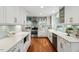 Modern kitchen layout with updated appliances and sleek white cabinets at 1218 Chimney Hill Dr, Apex, NC 27502