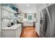 Bright kitchen featuring white cabinets, stainless steel appliances, and open shelving at 1218 Chimney Hill Dr, Apex, NC 27502