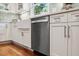Kitchen features a farmhouse sink, stainless steel dishwasher, and shaker style cabinets at 1218 Chimney Hill Dr, Apex, NC 27502