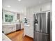 Well-lit kitchen showcases stainless steel refrigerator and white cabinetry at 1218 Chimney Hill Dr, Apex, NC 27502